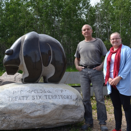 Stewart Steinhauer and Shelley Jodoin-Chouinard stand beside a new bear sculpture headed for MacEwan University